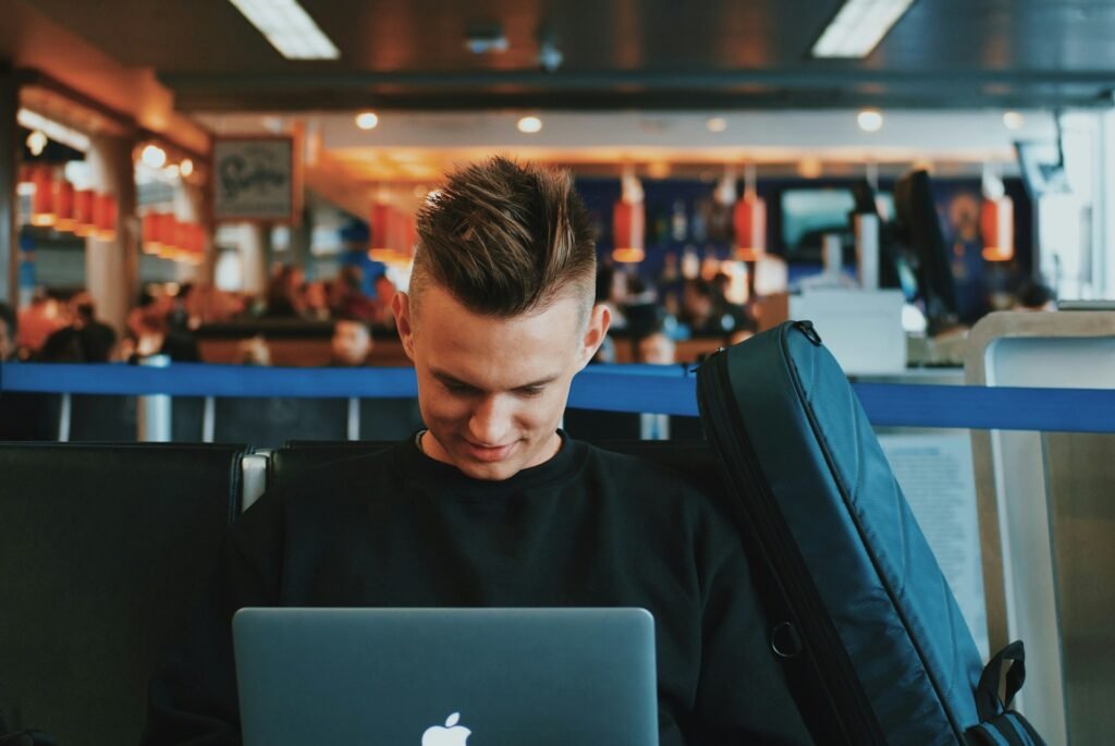 Remote worker using a laptop at an airport gate on public Wi-Fi
